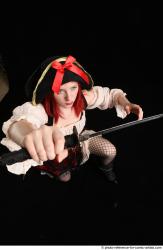 DARINA KNEELING POSES WITH DAGGER 